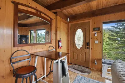a kitchen with a table and a door in a cabin at Stunning Views at Stargazer - Lakefront Studio in Crystal Bay