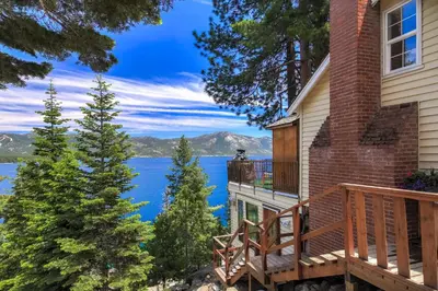 a house with a balcony with a view of the water at Stunning Views at Stargazer - Lakefront Studio in Crystal Bay