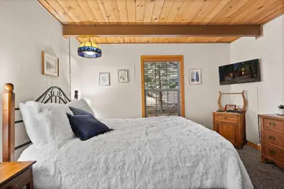 a bedroom with a bed and a wooden ceiling at Sundance - Foosball Table BBQ Near West Beach in Carnelian Bay