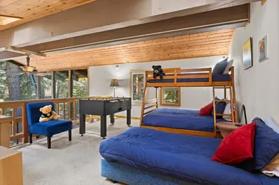 a bedroom with two bunk beds and a desk at Sundance - Foosball Table BBQ Near West Beach in Carnelian Bay