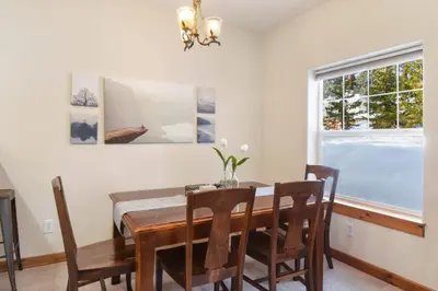 a dining room with a table and chairs and a window at Sunny Woods Acres - Near Golf & Adventure Park in Tahoe Vista
