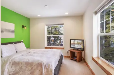 a bedroom with green walls and a bed and a television at Sunny Woods Acres - Near Golf & Adventure Park in Tahoe Vista