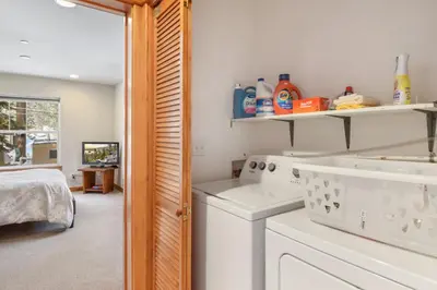 a white laundry room with a washer and dryer at Sunny Woods Acres - Near Golf & Adventure Park in Tahoe Vista
