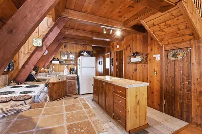 a kitchen with wooden cabinets and a white refrigerator at Beautiful Mountain Getaway in Kings Beach