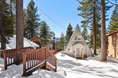a small house in the snow with a wooden bridge at Beautiful Mountain Getaway in Kings Beach