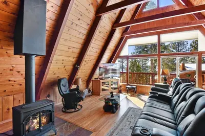 a living room with a fireplace in a log cabin at Beautiful Mountain Getaway in Kings Beach