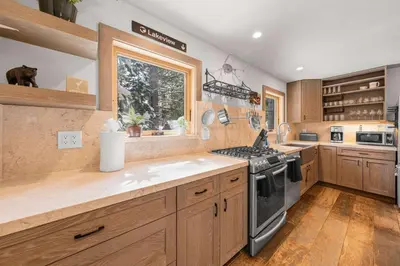 a kitchen with wooden cabinets and a stove top oven at Tahoe City Retreat - For 8 in Tahoe City