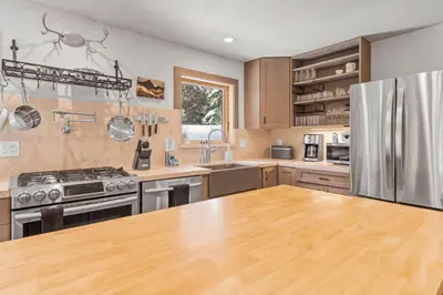 a kitchen with stainless steel appliances and wooden cabinets at Tahoe City Retreat - For 8 in Tahoe City