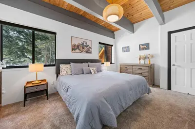 a bedroom with a large bed and windows at Tahoe City Retreat - For 8 in Tahoe City