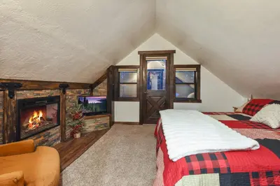 a bedroom with a bed and a fireplace at Tahoe Pines Cabin in Homewood