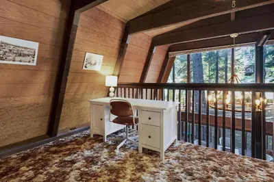 a desk and a chair in a room with a balcony at Truckee Cabin Getaway - Sleeps 6 in Truckee