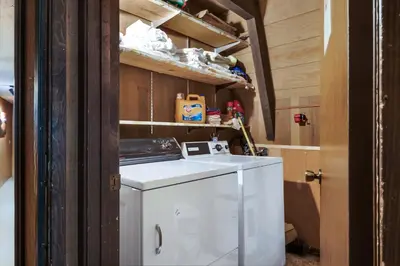 a small white refrigerator sitting inside of a room at Truckee Cabin Getaway - Sleeps 6 in Truckee