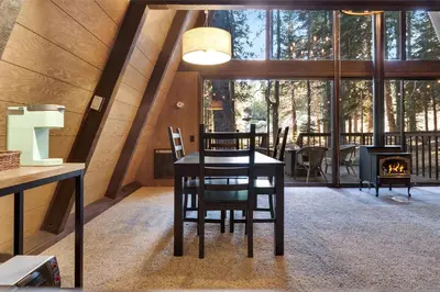 a dining room with a table and a fireplace at Truckee Cabin Getaway - Sleeps 6 in Truckee