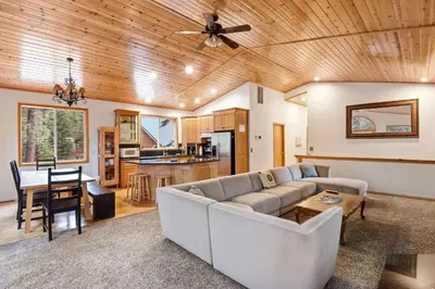 a living room with a couch and a table at Truckee Pines Retreat - Game Room & Forest Views in Truckee