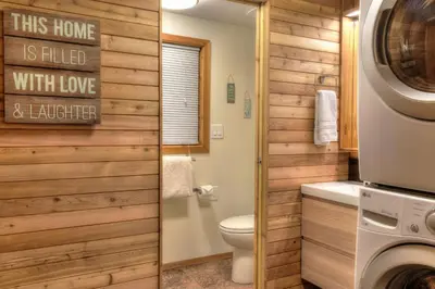 a bathroom with a toilet and a washer and dryer at Vista Point - 5 Minutes to Kings Beach in Tahoe Vista