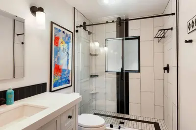 a bathroom with a shower and a toilet and a sink at Waters Edge Oasis - Shared Pool & Pier Access in Tahoma