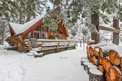 a log cabin in the snow with snow covered trees at West Shore Haven - Near Beach & Outdoor Fun in Tahoma