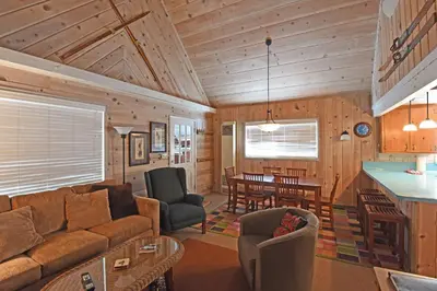 a living room with a couch and a table at Woodland Chalet - 2 miles from Beach Access in Tahoma