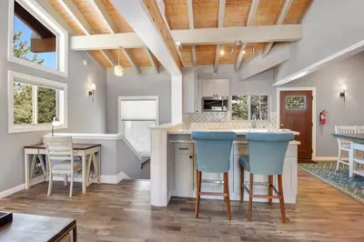a kitchen with a center island with blue bar stools at Alpine Chalet Nature Lovers Rejoice Chic 4 BDR in Alpine Meadows