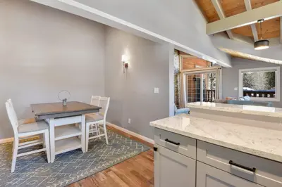 a kitchen with a table and chairs in a room at Alpine Chalet Nature Lovers Rejoice Chic 4 BDR in Alpine Meadows