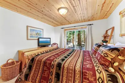 a bedroom with a bed and a television in it at Alpine Gem Near Homewood Mountain in Tahoma