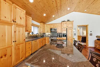 a large kitchen with wooden cabinets and a large island at Alpine Gem Near Homewood Mountain in Tahoma