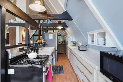 a kitchen with a stove and a sink at Woodside Hideout - Hop Away from Activities in Tahoma