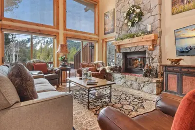 a large living room with a stone fireplace at Wulf's Lodge at Olympic Valley - Unwind in Hot Tub in Olympic Valley