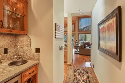 a kitchen with a sink and a living room at Wulf's Lodge at Olympic Valley - Unwind in Hot Tub in Olympic Valley
