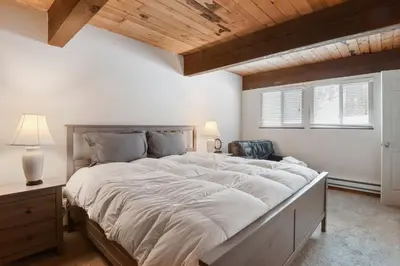 a bedroom with a large bed with a wooden ceiling at Alpine Manor Retreat Mountain Relaxation in Alpine Meadows