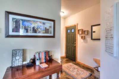 a hallway with a desk with books and a door at Alpine Way Lake & Sugar Bowl Resort in Truckee