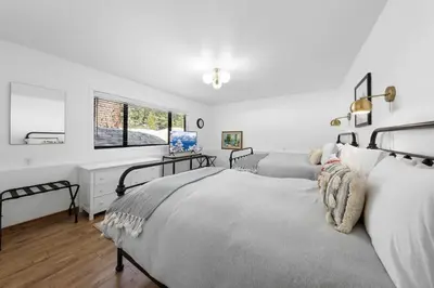 a bedroom with two beds and a desk at Bright & Modern Cabin Luxury Home in Carnelian Bay in Carnelian Bay