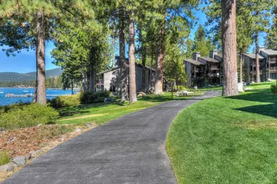 a driveway leading up to a house with trees at Brockway Springs Lodge Steps to Lake Access in Kings Beach