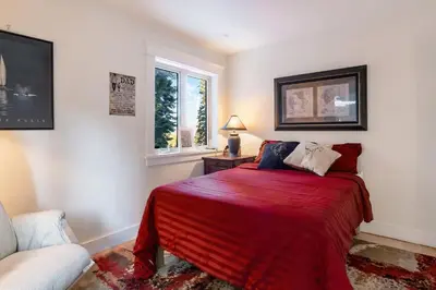 a bedroom with a bed with a red blanket at Carnelian Bay Getaway in Carnelian Bay