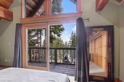 a bedroom with a bed and a large window at Carnelian Bay Getaway in Carnelian Bay