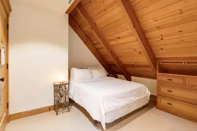 a bedroom with a white bed and a wooden ceiling at Carnelian Bay Getaway in Carnelian Bay
