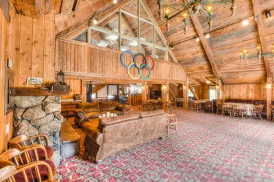 a living room with a couch and a stone wall at Granlibakken Retreat Near Tahoe Beach in Tahoe City