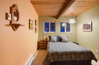 a bedroom with a bed and two windows at Comfy Alpine Meadows Endless fun in Alpine Meadows