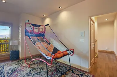 a room with a tennis racket on the wall at Hilltop Hideaway w Game Room & Forest Views in Truckee