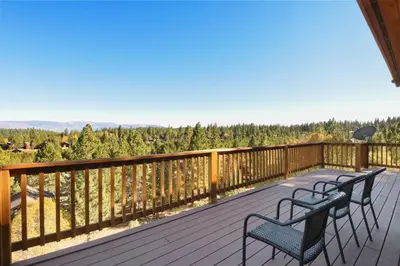 two benches on a deck with a view of trees at Hilltop Hideaway w Game Room & Forest Views in Truckee