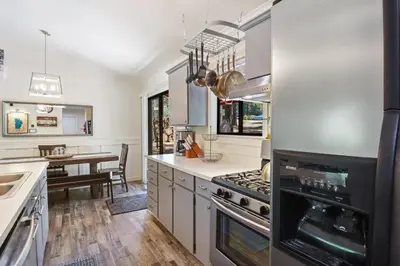 a kitchen with stainless steel appliances and a dining table at Incline Bliss Dreamy Pet Friendly Escape in Incline Village