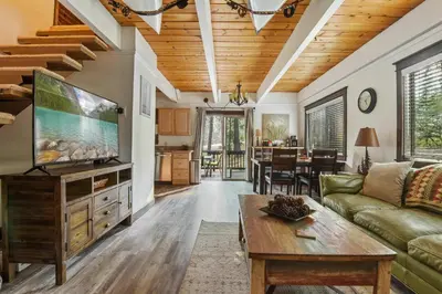 a living room with a couch and a tv at Incline Cottage Year-Round Outdoor Fun in Incline Village