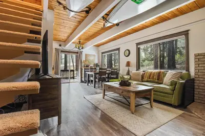 a living room with a couch and a table at Incline Cottage Year-Round Outdoor Fun in Incline Village