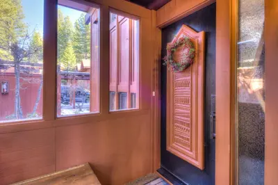 a door with a wreath on it next to windows at Crystal Shores Villa Lake Views & Hiking in Incline Village
