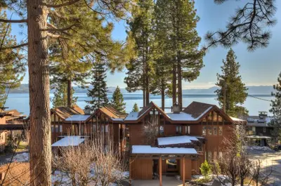 a house in the woods with snow on the ground at Crystal Shores Villa Lake Views & Hiking in Incline Village