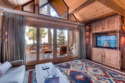 a living room with a couch and a tv at Crystal Shores Villa Lake Views & Hiking in Incline Village