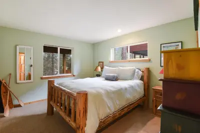 a bedroom with a bed and two windows at Kings Beach Bliss Walk to Outdoor Fun in Kings Beach