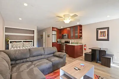 a living room with a couch and a kitchen at Kings Run Retreat Patio in Tahoe Vista