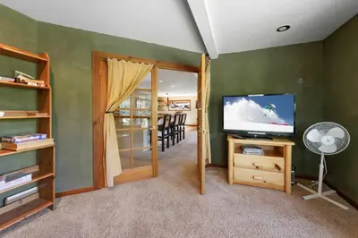 a living room with a television and a dining room at Kitzbuhel Paradise Sleeps 8 in Truckee