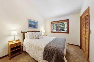 a bedroom with a large bed and a window at Kitzbuhel Paradise Sleeps 8 in Truckee